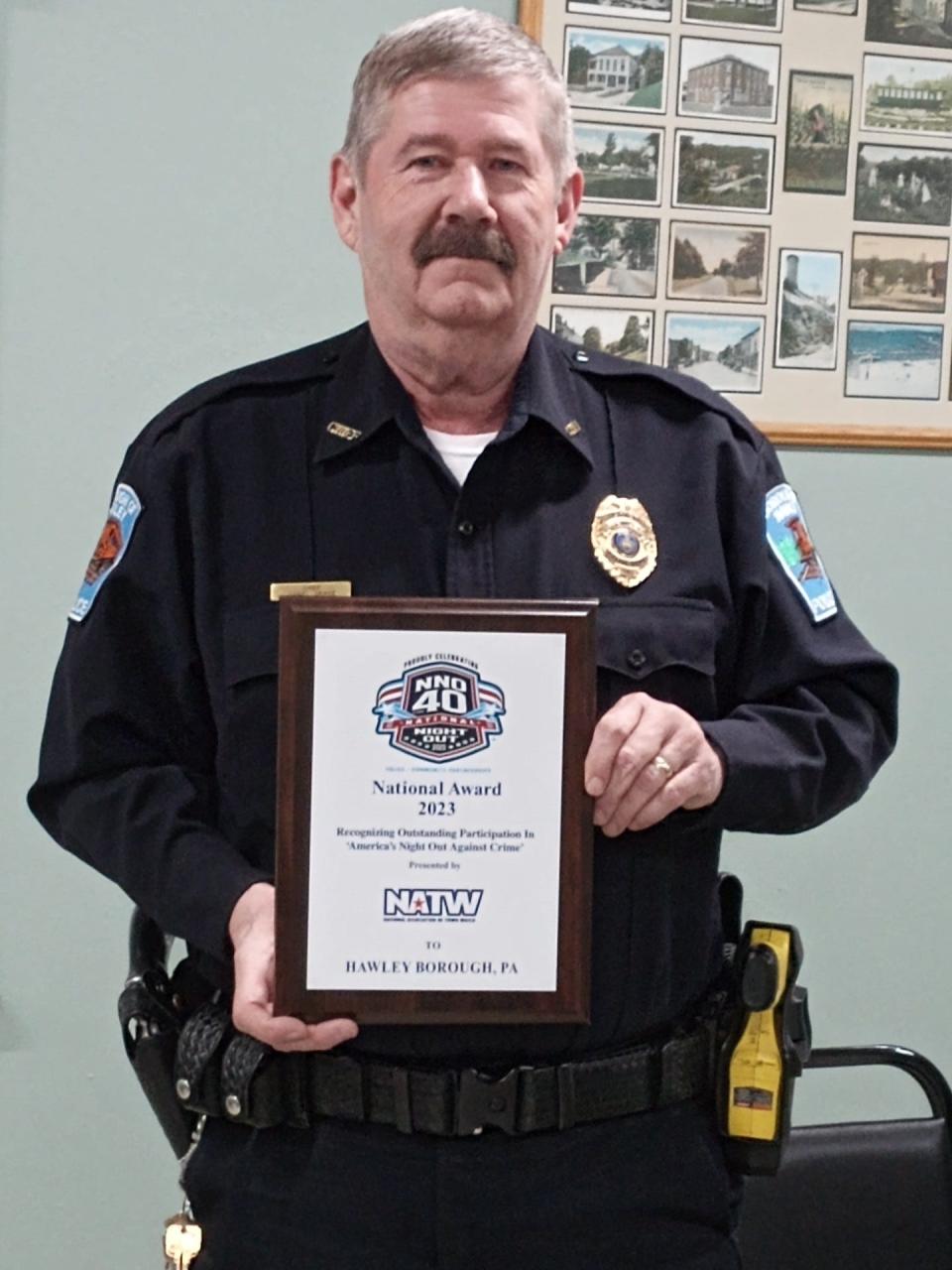 Hawley Police Chief Daniel Drake holds a plaque awarded to the borough for its National Night Out community crime and drug abuse prevention event in August 2023. Hawley has held the event for approximately 30 years under Drake's leadership.