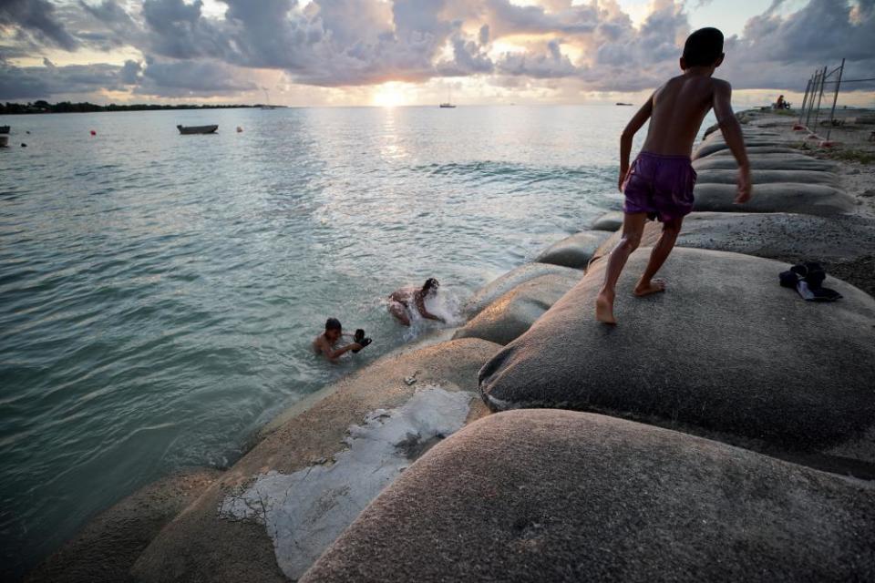 Boys play in the lagoon in Funafuti, Tuvalu.