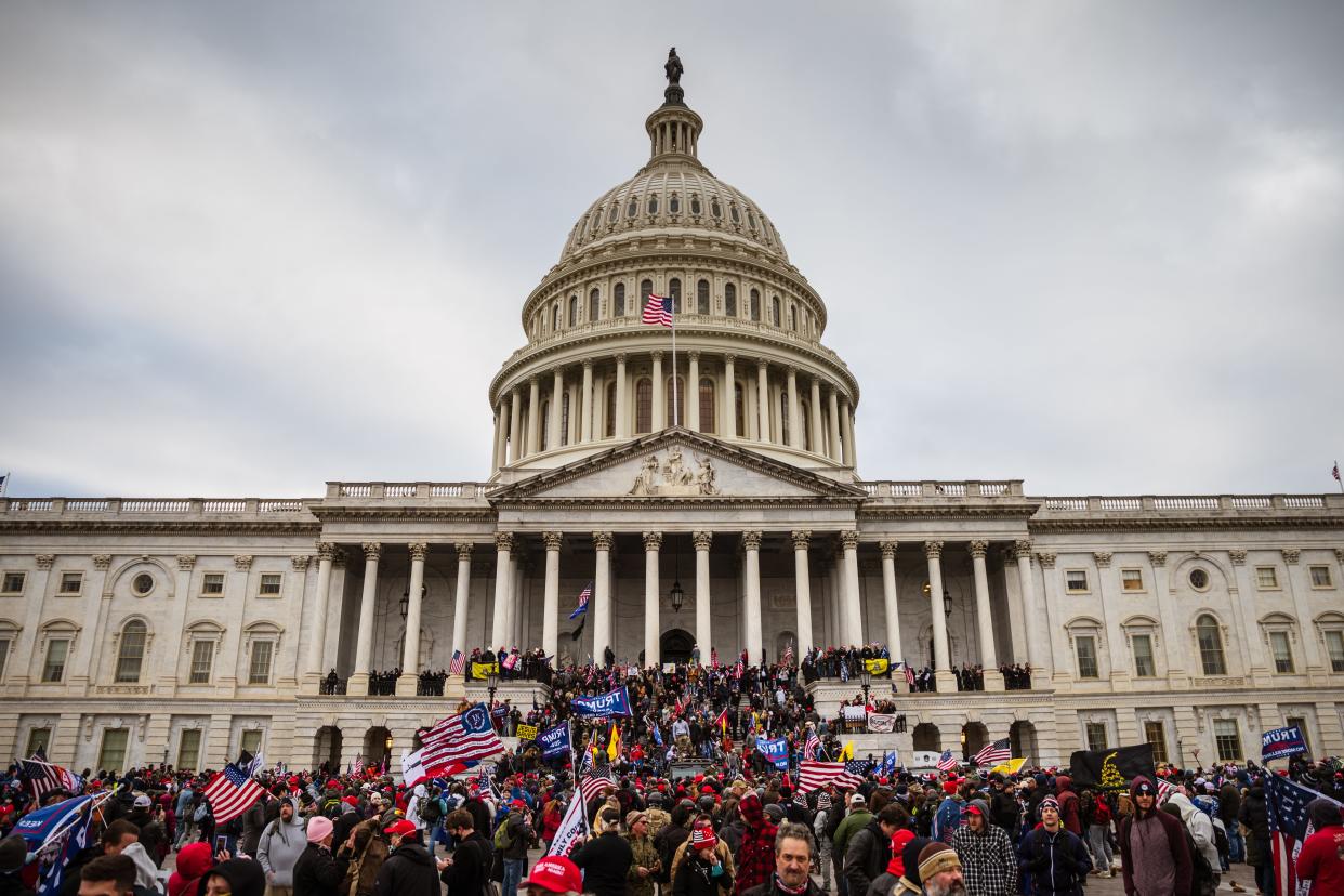 <p>A large group of pro-Trump protesters stand on the East steps of the Capitol Building after storming its grounds on 6 January 2021 in Washington, DC</p> ((Getty Images))