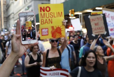 People protesting against U.S. President Donald Trump's immigration policies are captured on a cellular phone during a demonstration in New York City, U.S., June 26, 2018. REUTERS/Brendan Mcdermid