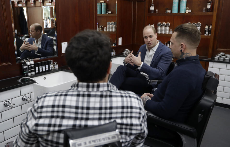 William speaks to Dean Hamilton (right) and Paul Richardson during a visit to Pall Mall Barbers [Photo: PA]