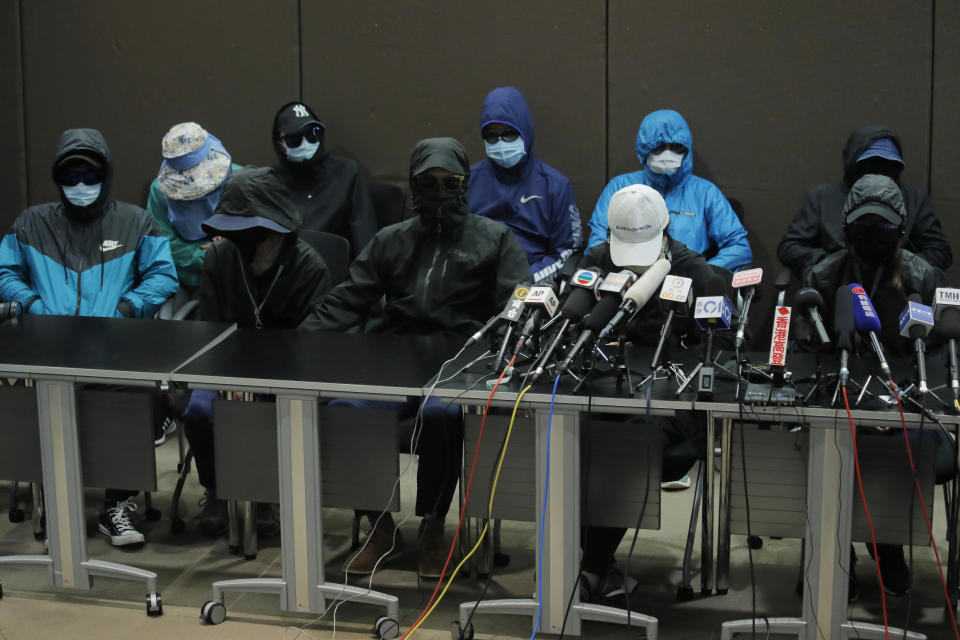 In this Saturday, Sept. 12, 2020 photo, relatives of 12 Hong Kong activists detained at sea by Chinese authorities attend a press conference in Hong Kong. Police in Hong Kong say they have arrested nine people on suspicion of providing funds and other assistance to a group of 12 who sought to flee the territory by boat in August but were intercepted by Chinese authorities. (AP Photo/Kin Cheung)