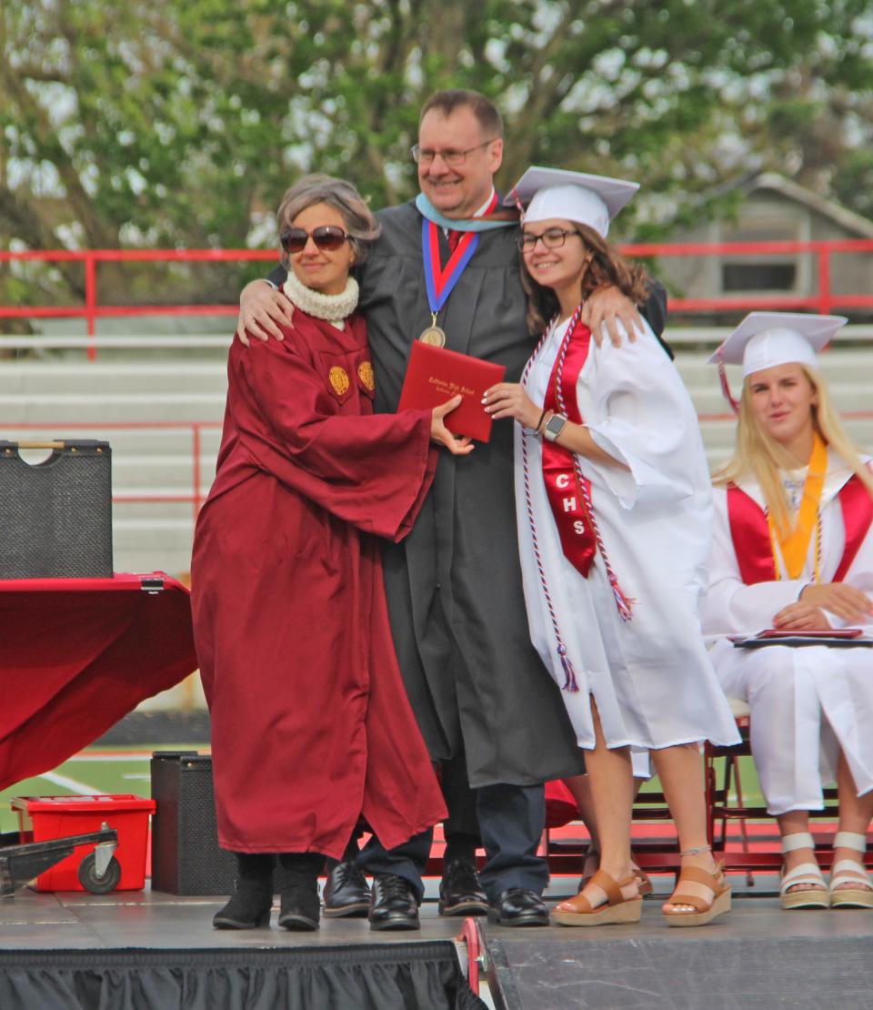 Coldwater graduate Anissa Stevens poses with her parents, faculty members Brian Stevens and Carolyn Youssef, Sunday at graduation.