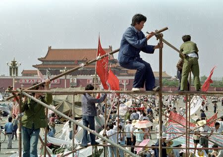 FILE PHOTO: Student protesters construct a tent to protect them from the elements in Tiananmen Square in Beijing, China, May 26, 1989. REUTERS/Shunsuke Akatsuka/Files