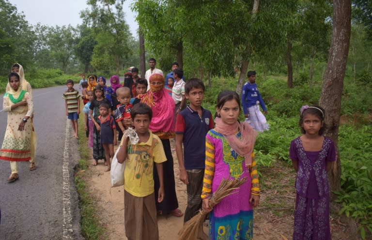 Rohingya refugees walk beside the Teknaf-Cox's Bazar highway near Kutupalong refugee camp in Ukhiya, Bangladesh, on September 3, 2017