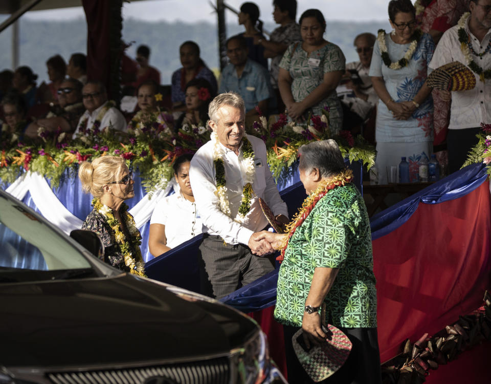 Prime Minister Tuilaepa Sailele Malielegaoi, foreground right, shakes hands with Robert F. Kennedy Jr. before he left the the 57th Independence Celebration in Mulinu’u, Samoa, on June 1, 2019. At foreground left is Kennedy's wife, actress Cheryl Hines. Kennedy said the trip was arranged by Edwin Tamasese, a local anti-vaccine influencer. (Misiona Simo/Samoa Observer via AP)