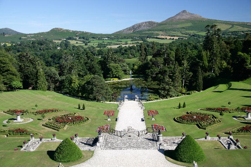 This undated photo from the Powerscourt Estate shows the gardens and grounds of the estate in Enniskerry, County Wicklow, Ireland, with the Wicklow Mountains in the background. The Powerscourt Estate and other great houses, castles and gardens in Ireland are hosting events connected to The Gathering, a yearlong nationwide event inviting Irish emigrants and their descendants home to celebrate their heritage. Powerscourt recently hosted a talk by a genealogist to help visitors track their “Wicklow roots.” (AP Photo/Powerscourt Estate)