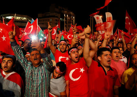 Supporters of Turkish President Tayyip Erdogan shout slogans and wave Turkish national flags during a pro-government demonstration on Taksim square in Istanbul, Turkey, July 18, 2016. REUTERS/Ammar Awad