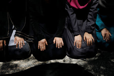 REFILE - CORRECTING BYLINE Palestinians pray at an entrance to the compound known to Muslims as Noble Sanctuary and to Jews as Temple Mount in Jerusalem's Old City July 16, 2017. REUTERS/Ronen Zvulun