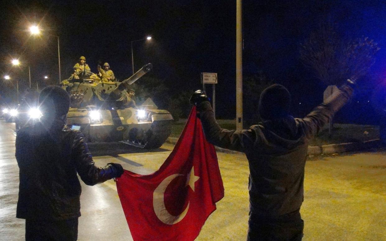 Cheering Turks wave toward tanks heading toward the Syrian border early on Sunday - DHA-Depo Photos