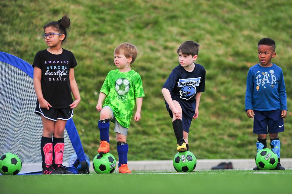 Children wait for instruction at the Emerald Youth Sports Complex in Lonsdale, Tenn on Monday, March 21, 2022.