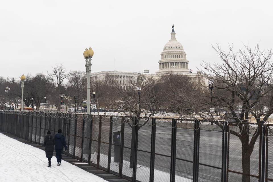 The U.S. Capitol is seen behind the metal security fencing around the U.S. Capitol, Thursday, Feb. 18, 2021. U.S. Capitol Police officials told congressional leaders the razor-wire topped fencing around the Capitol should remain in place for several more months as law enforcement continues to track threats against lawmakers, a person familiar with the matter told The Associated Press on Thursday. (AP Photo/Manuel Balce Ceneta)