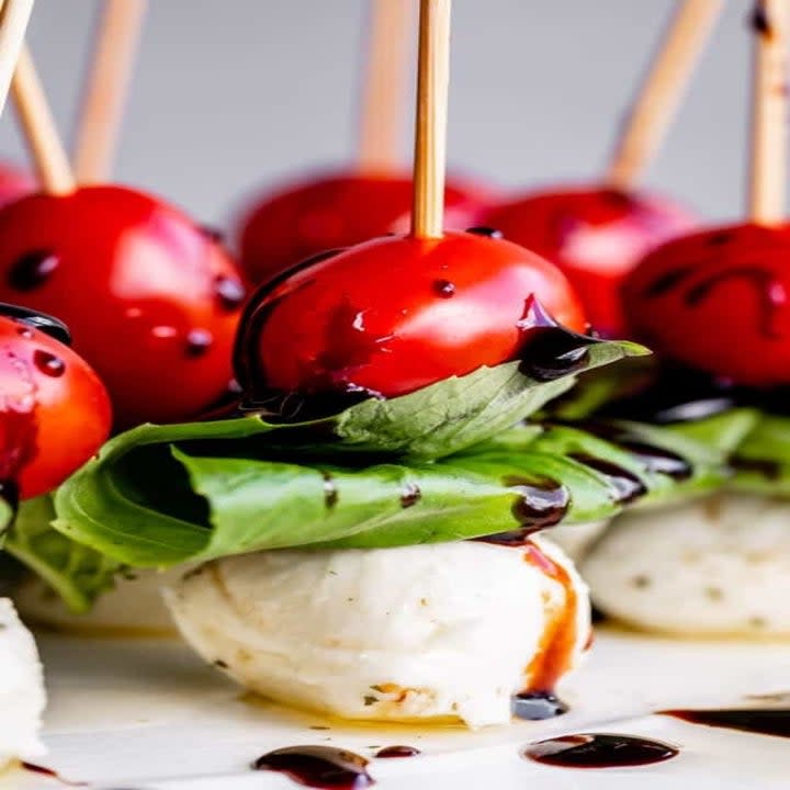 A skewer with tomato, mozzarella, and basil.