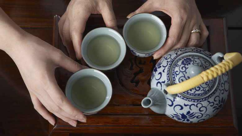 Teapot with three teacups
