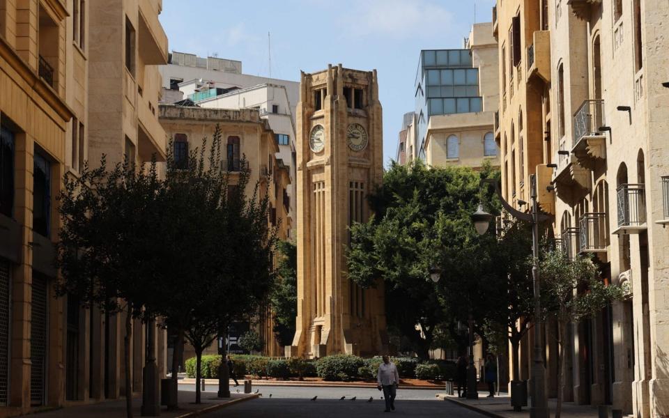 Clock tower in front of the parliament building in Beirut after a decision to postpone the start of daylight saving - Anwar Amro/AFP