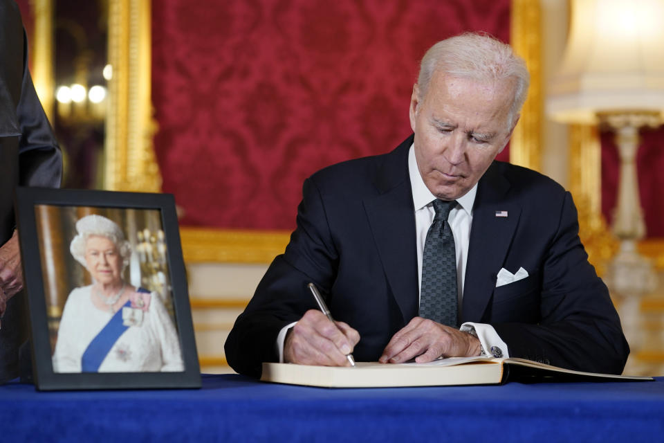President Joe Biden signs a book of condolence at Lancaster House in London, following the death of Queen Elizabeth II, Sunday, Sept. 18, 2022. (AP Photo/Susan Walsh)
