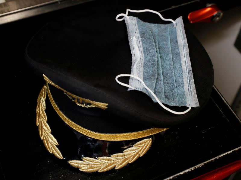 FILE PHOTO: A pilot's hat and a protective face mask are seen inside a Boeing 737-800 plane of Ukrainian low-cost airline SkyUp at the Boryspil International Airport outside Kiev