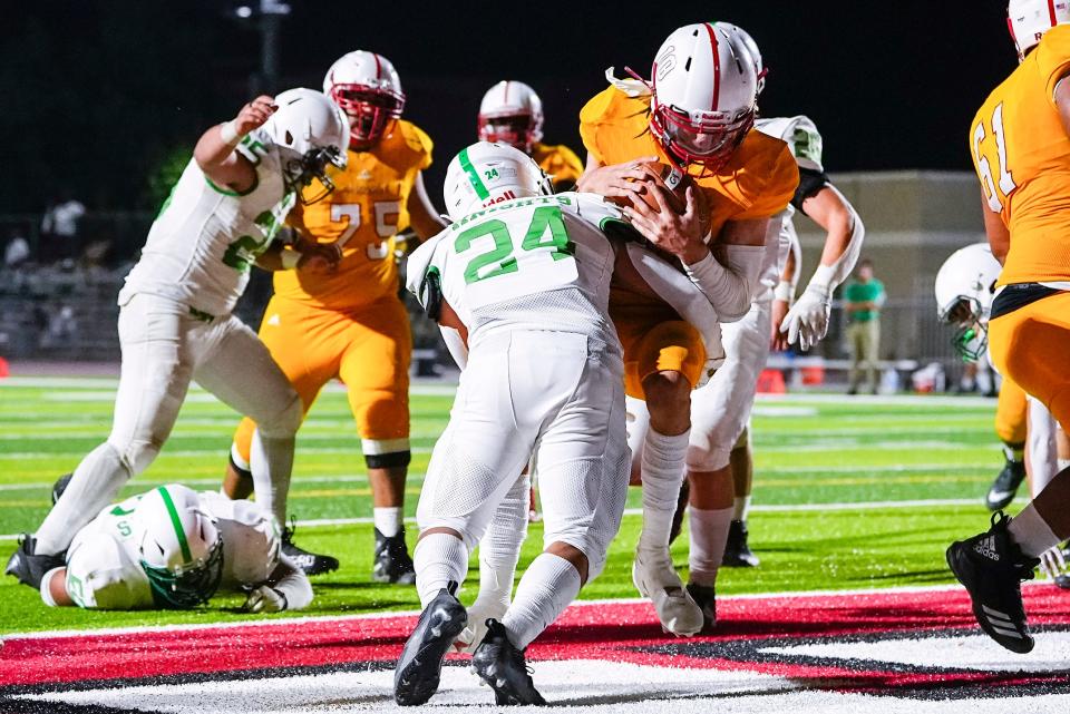 Zecheriah Owens (10 of Glendale), center, scores a touchdown during a game against St. Mary's Catholic High School at Glendale Union High School on Friday, Oct. 29, 2021, in Glendale. The game finished 33-21 to Glendale. 