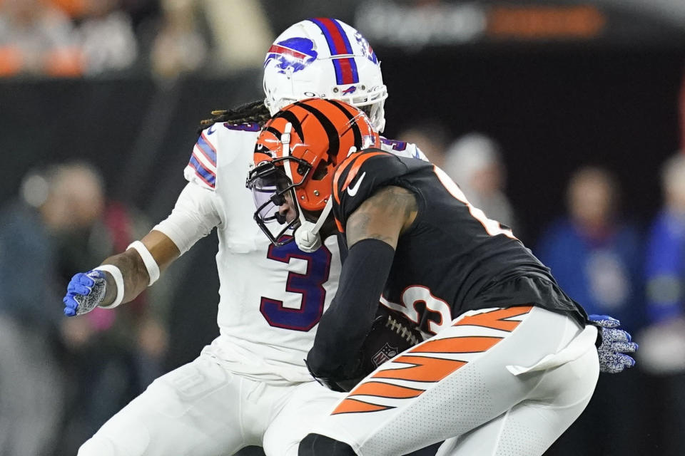 Cincinnati Bengals wide receiver Tee Higgins (85) runs near Buffalo Bills safety Damar Hamlin (3) during the first half of an NFL football game, Monday, Jan. 2, 2023, in Cincinnati. Hamlin was injured on the play. The game has been postponed after Buffalo Bills' Damar Hamlin collapsed, NFL Commissioner Roger Goodell announced. (AP Photo/Joshua A. Bickel)