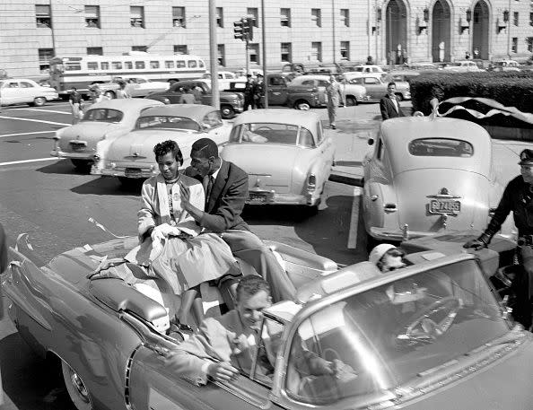 SAN FRANCISCO, CA - MARCH 22: (l-r) Rose Swisher and Bill Russell, ride in a victory parade celebrating the University of San Francisco's national basketball championship in San Francisco, CA., on March 22, 1955. USF defeated LaSalle 77-63 in the championship game on March 19, 1955. (Bob Campbell/San Francisco Chronicle via Getty Images)