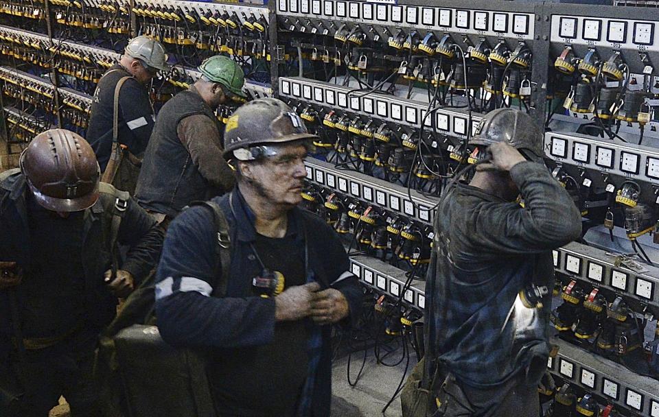 FILE - In this Nov. 21, 2018, file photo, miners put away their equipment after an underground shift at the Wujek coal mine in Katowice, in Poland's southern mining region of Silesia. The coronavirus has ripped through Poland's coal mines, where men descend deep underground in tightly packed elevators and work shoulder-to-shoulder. The virus hot spots, centered in the southern Silesia region, have paralyzed an already-troubled industry, forcing many to stay home from work and triggering a three-week closure of many state-run mines. (AP Photo/Czarek Sokolowski, File)