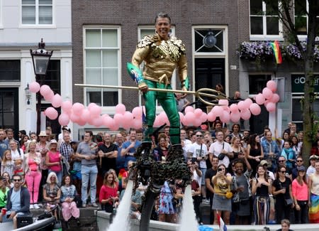 A participant cruises the canals during the annual gay pride parade in Amsterdam