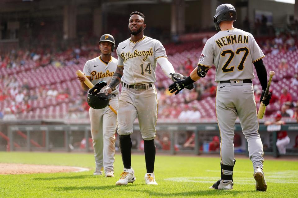 Kevin Newman (27) congratulates Pirates designated hitter Rodolfo Castro after scoring in a game against the Reds on Sept. 14.