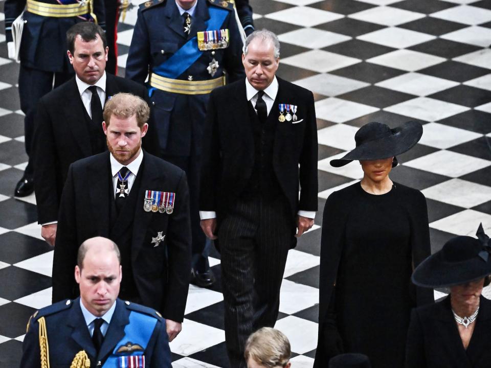 Prince Harry and Meghan Markle exit the Queen's funeral at Westminster Abbey.