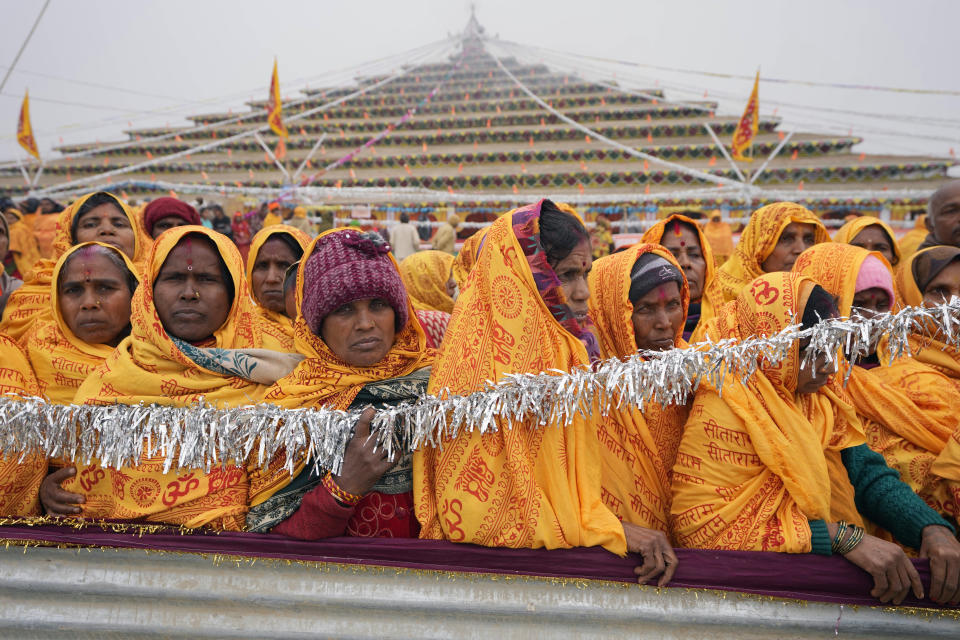 Hindu devotees participate in a religious ritual at a camp erected for people arriving to attend the Monday opening of a temple dedicated to Hindu deity Lord Ram in Ayodhya, India, Friday, Jan. 19, 2024. Three decades after Hindu mobs tore down a historical mosque, Indian Prime Minister Narendra Modi will attend the consecration of a grand Hindu temple at the same site on Monday in a political move to boost his party ahead of a crucial national vote. (AP Photo/Rajesh Kumar Singh)