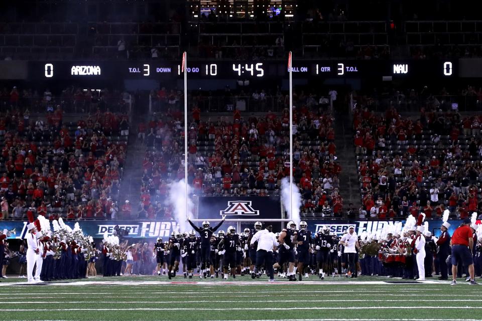 Arizona Wildcats runs onto the field for their first game of the season before the first half at Arizona Stadium in Tucson on Sept. 2, 2023.