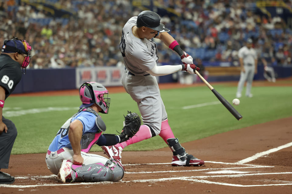 New York Yankees' Aaron Judge singles in front of Tampa Bay Rays catcher Ben Rortvedt during the first inning of a baseball game Sunday, May 12, 2024, in St. Petersburg, Fla. (AP Photo/Mike Carlson)