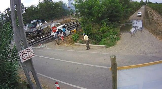 Locals gather round the smashed lorry after the horrific accident. Picture: LiveLeak