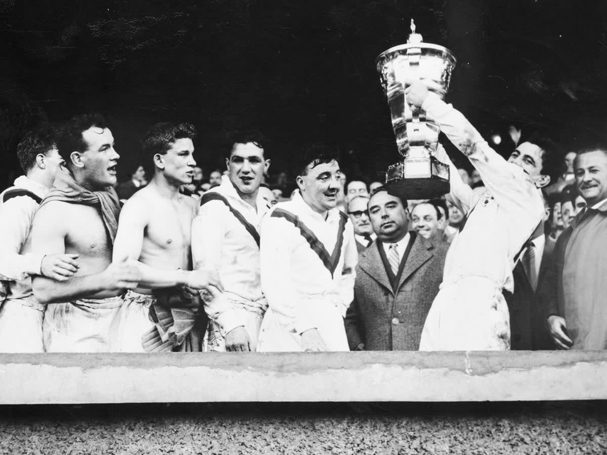 Victorious Great Britain players hold aloft the trophy after winning the inaugural Rugby League World Cup (Bettmann Archive)