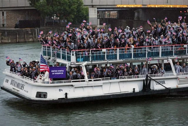 <p>Jared C. Tilton/Getty</p> Team USA cruises down the Seine during the opening ceremony.