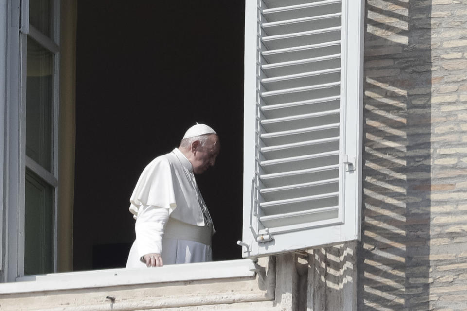 Pope Francis leaves after delivering his blessing at the Vatican, Sunday, March 22, 2020. During his weekly Sunday blessing, held due to virus concerns in his private library in the Apostolic Palace, he urged all Christians to join in reciting the ‘’Our Father’’ prayer next Wednesday at noon. And he said that he would lead a global blessing to an empty St. Peter’s Square on Friday. For most people, the new coronavirus causes only mild or moderate symptoms. For some it can cause more severe illness, especially in older adults and people with existing health problems. (AP Photo/Andrew Medichini)