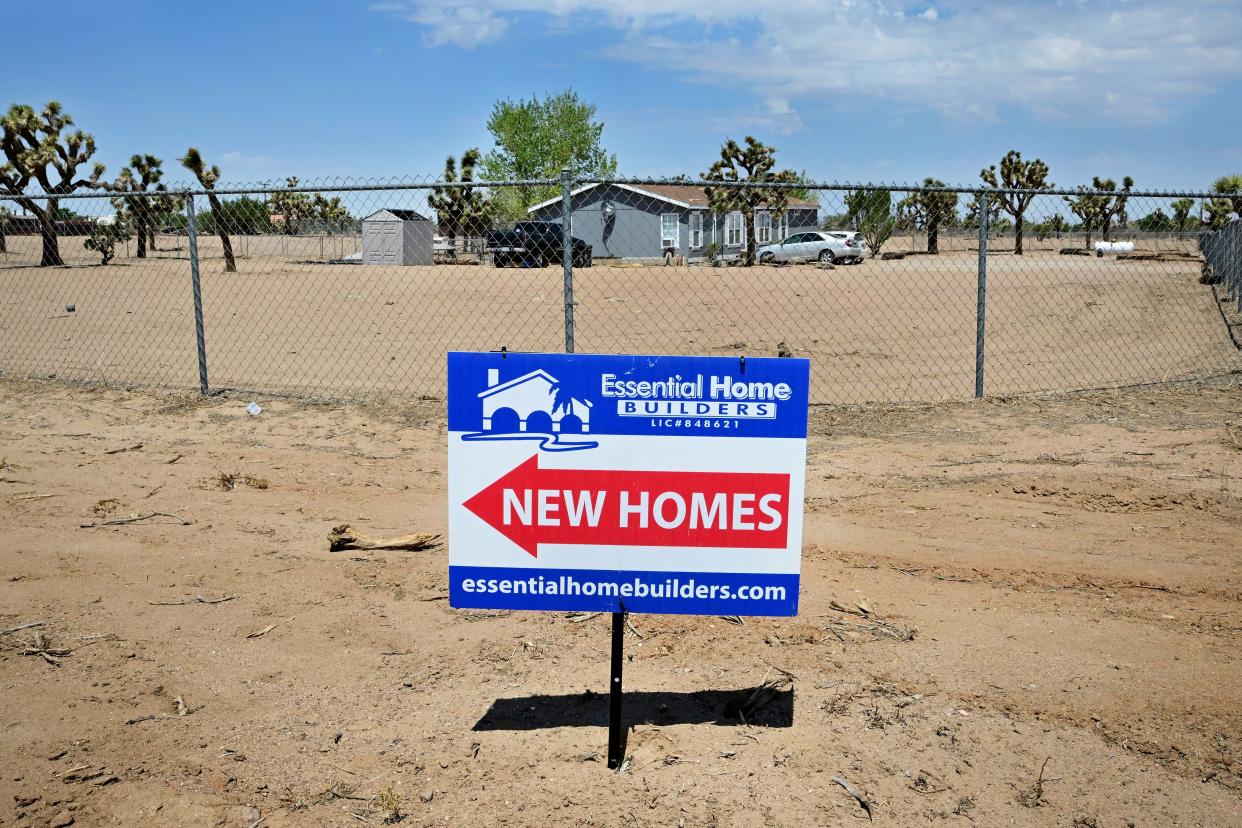 A sign points to new homes in Hesperia, California on August 18, 2022. U.S. home sales fell nearly 6% in July, 2022 as the housing market slides into a recession. (Photo by Frederic J. BROWN / AFP) 