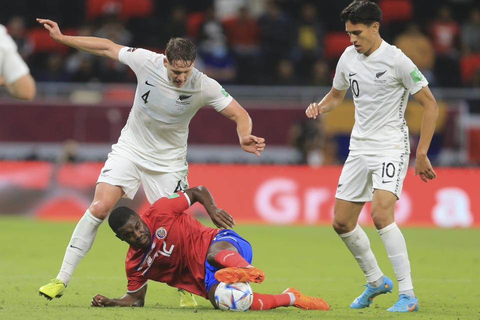 New Zealand's Mamdo Pijnaker, top, and Costa Rica's Joel Campbell fight for the ball during the World Cup 2022 qualifying play-off soccer match between New Zealand and Costa Rica in Al Rayyan, Qatar, Tuesday, June 14, 2022. (AP Photo/Hussein Sayed)