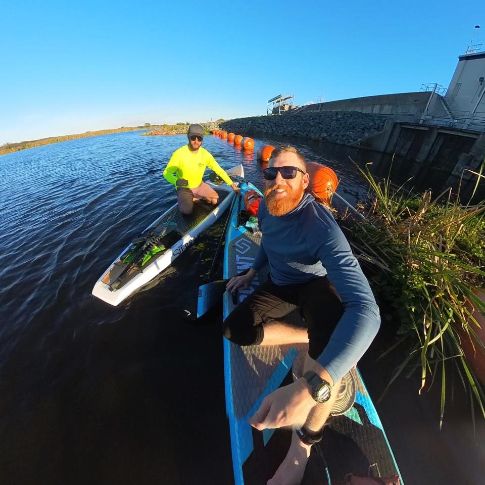 Mason Gravley, front, and Jordon Wolfram celebrate after reaching the end of their journey across Lake Okeechobee on stand-up paddleboards. The friends say they are the first to paddle the length of Florida's largest lake.