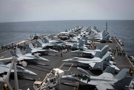 Flight deck of the U.S aircraft carrier USS Abraham Lincoln (CVN 72) is seen as sailors swip the deck for foriegn object and debris (FOD) walk-down on the flight deck of the Nimitz-class aircraft carrier USS Abraham Lincoln (CVN 72) in Arabian Sea