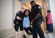 <p>A demonstrator is taken into custody by U.S. Capitol Police as activists protest against the Republican health care bill outside the offices of Sen. Jeff Flake and Sen. Ted Cruz, Monday, July 10, 2017, on Capitol Hill in Washington. (Photo: J. Scott Applewhite/AP) </p>