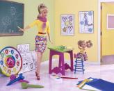 <p>Art Teacher Barbie brings a creative sense of style to the classroom, with a brightly-patterned skirt, fun scarf and a bright red belt that matches her shoes.</p>