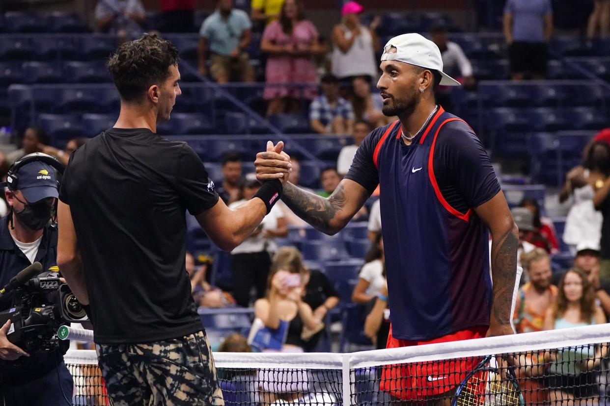Nick Kyrgios, right, of Australia, shakes hands with Thanasi Kokkinakis, of Australia, during the first round of the U.S. Open tennis championship on Monday, Aug. 29, 2022, in New York.