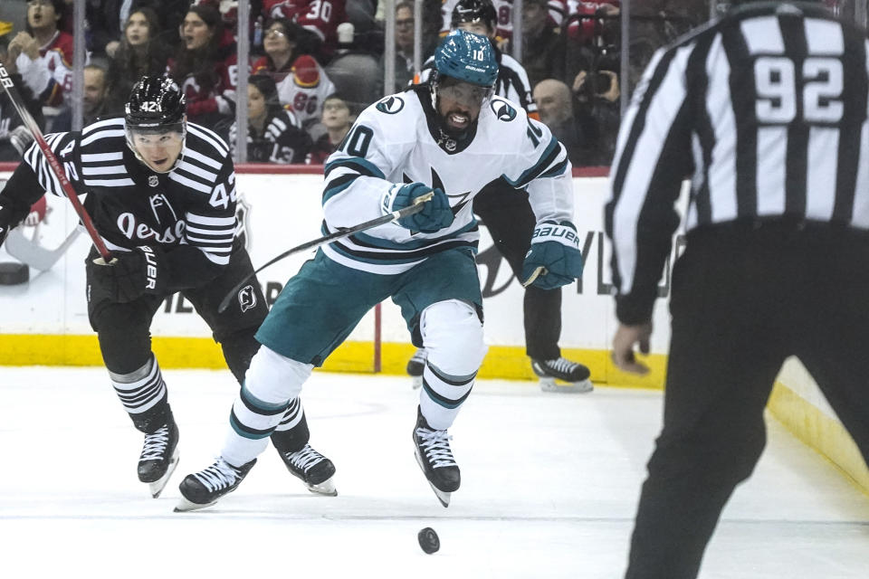 San Jose Sharks' Anthony Duclair chases the puck during the first period of the team's NHL hockey game against the New Jersey Devils, Friday, Dec. 1, 2023, in Newark, N.J. (AP Photo/Bebeto Matthews)