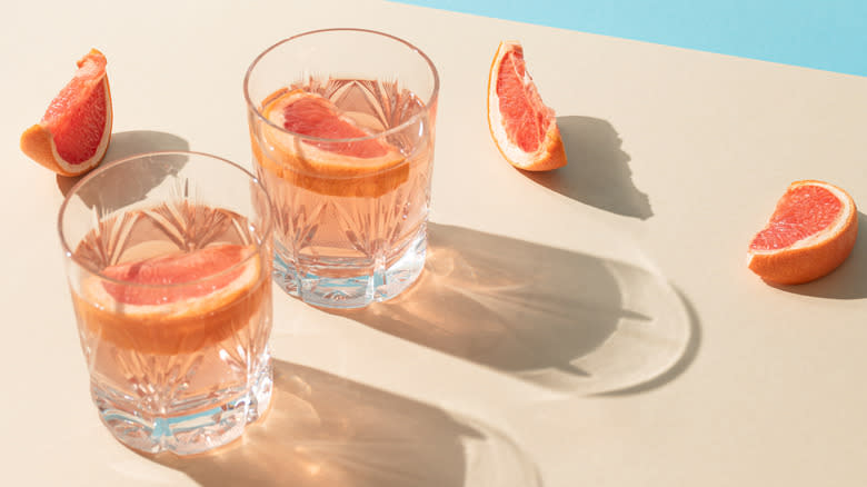 Pink cocktails with grapefruit garnish
