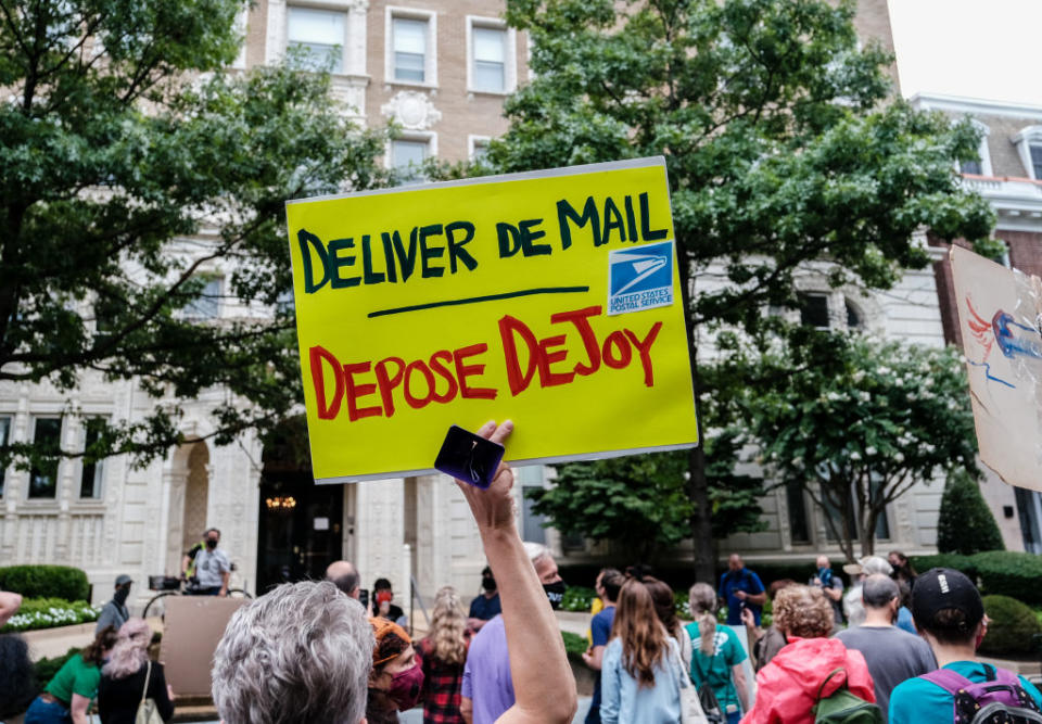 Demonstrators gather outside of the condo of President Donald Trump donor and current U.S. Postmaster General Louis Dejoy on August 15, 2020 in Washington, DC. | Michael A. McCoy—Getty Images