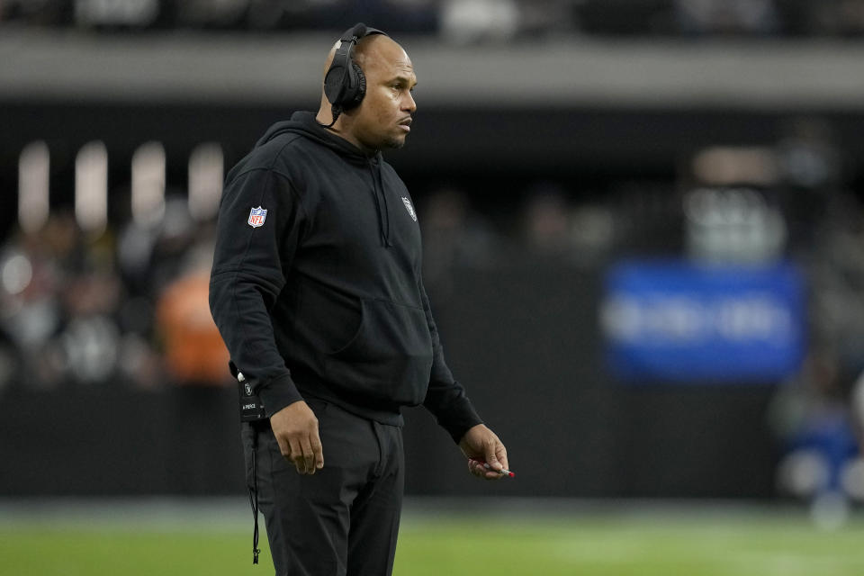 Las Vegas Raiders interim head coach Antonio Pierce stands on the field during the first half of an NFL football game against the Kansas City Chiefs, Sunday, Nov. 26, 2023, in Las Vegas. (AP Photo/John Locher)