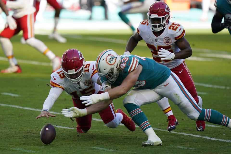 Kansas City Chiefs quarterback Patrick Mahomes (15) and Miami Dolphins outside linebacker Andrew Van Ginkel (43) go after the football after Mahomes fumbled the snap, during the first half of an NFL football game, Sunday, Dec. 13, 2020, in Miami Gardens, Fla. The Chiefs recovered the ball. (AP Photo/Wilfredo Lee)