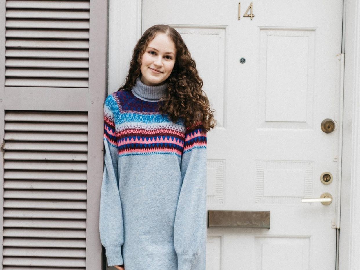 Woman posing by door for photo