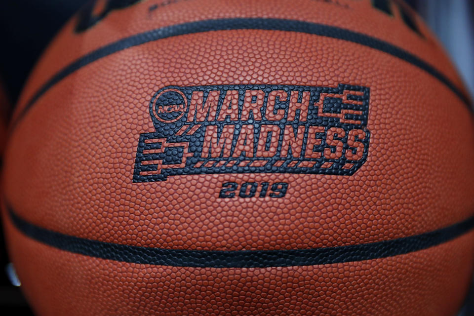 A basketball with a logo is seen before a first round men's college basketball game between Minnesota and Louisville in the NCAA Tournament, Thursday, March 21, 2019, in Des Moines, Iowa. (AP Photo/Charlie Neibergall)