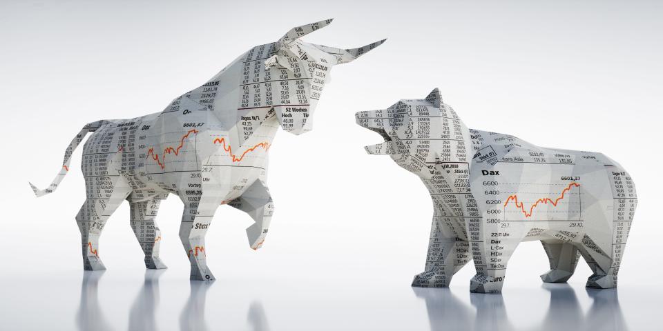 Bull and bear figurines with stock market overlay